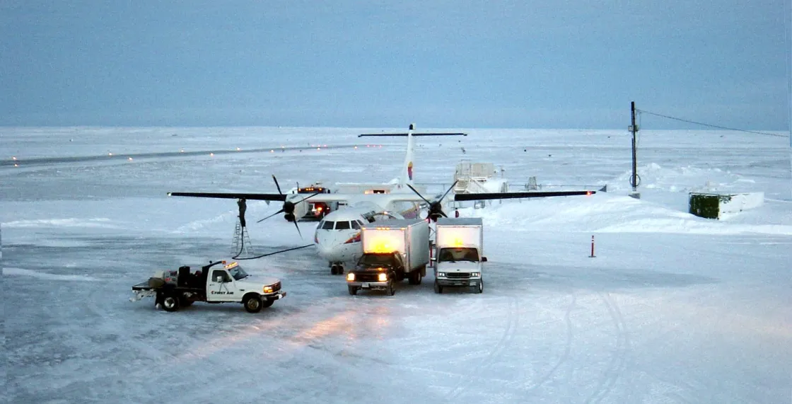 Photo of plane unloading on icy pavement