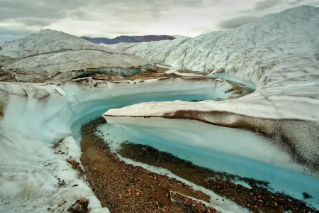 meltwater cuts into Greenland ice sheet, exposing dirt meltwater cuts into Greenland ice sheet, exposing dirt
