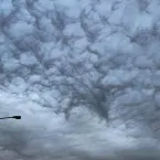 Asperitas clouds linger over the southern Greenland town of Narsaq on August 22, 2023. 